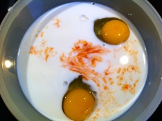 The eggs are accompanied by milk and hot sauce.